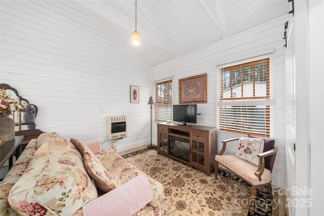 living area with vaulted ceiling with beams and heating unit