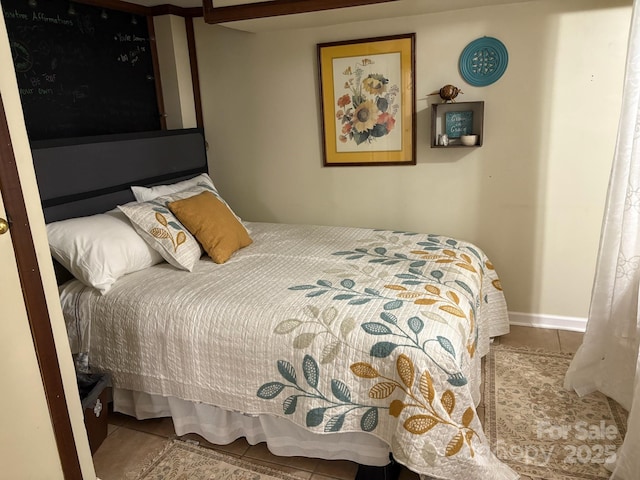 bedroom featuring baseboards and tile patterned floors