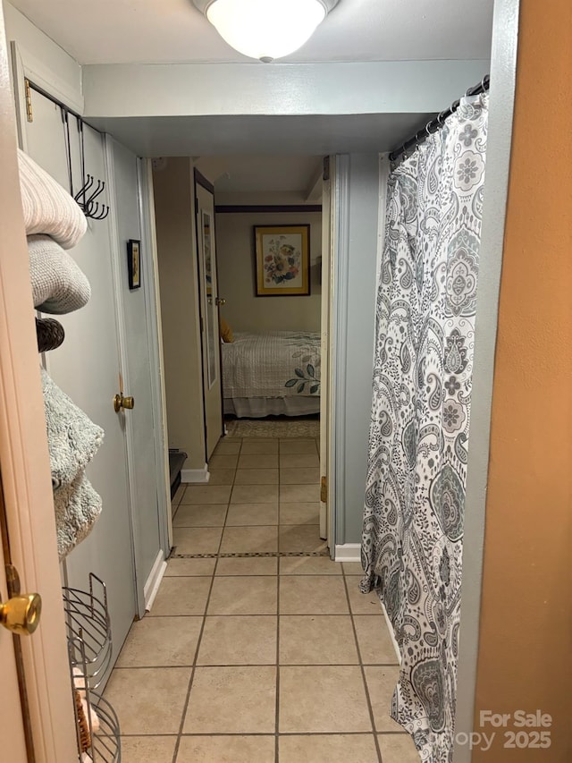 corridor featuring light tile patterned floors