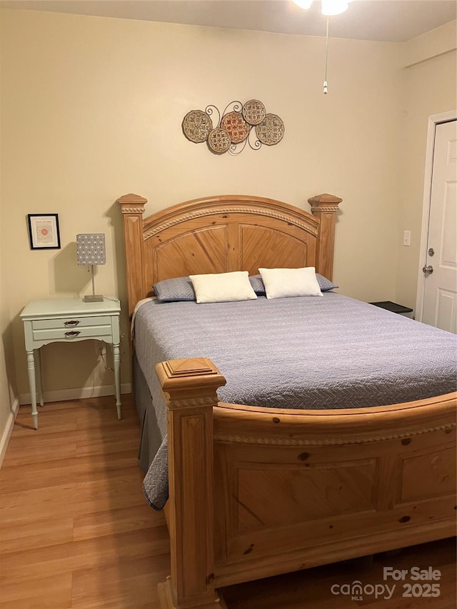 bedroom featuring light wood-type flooring and baseboards