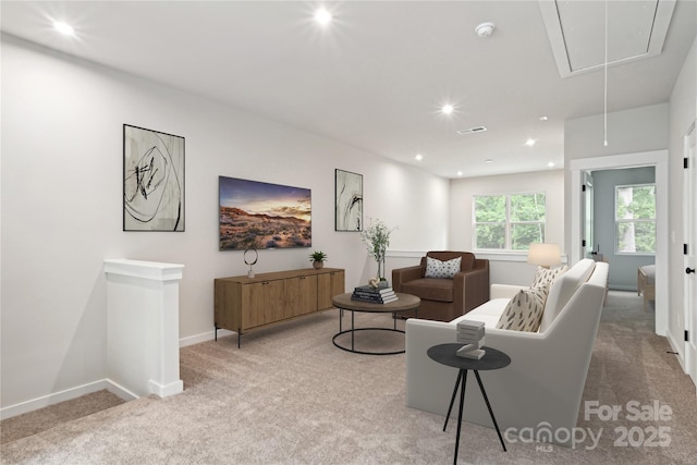 living room featuring recessed lighting, light colored carpet, visible vents, attic access, and baseboards