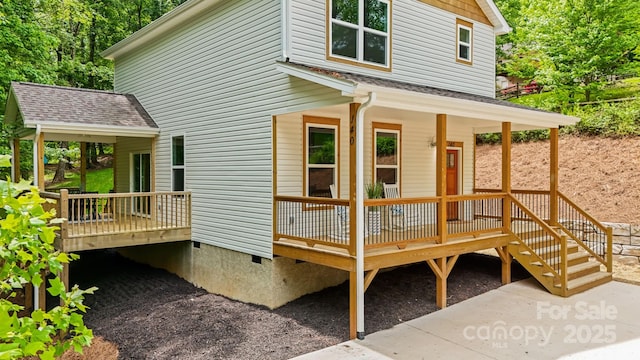 exterior space featuring a shingled roof and crawl space