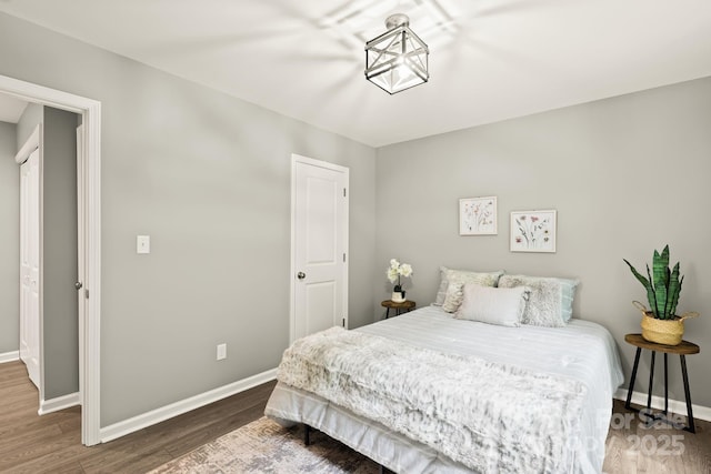 bedroom with baseboards and wood finished floors