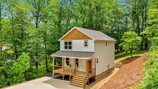 view of front of home featuring crawl space, a porch, and roof with shingles