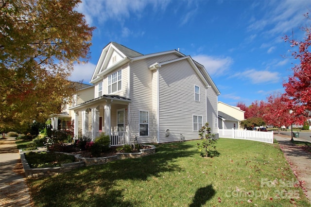 view of side of property featuring a yard and fence