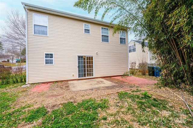 rear view of property featuring a patio and fence