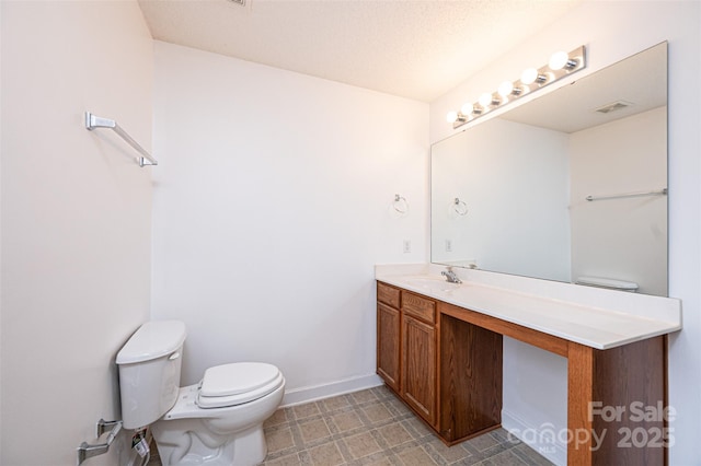 bathroom with visible vents, baseboards, toilet, tile patterned floors, and vanity