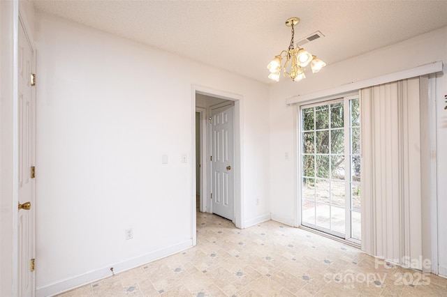 spare room featuring visible vents, baseboards, light floors, a notable chandelier, and a textured ceiling