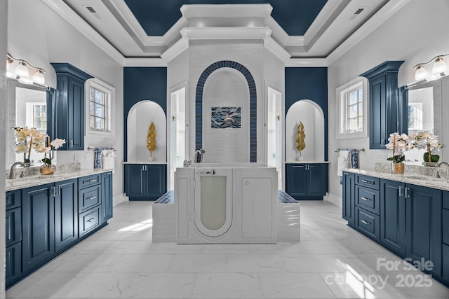 full bathroom with ornamental molding, marble finish floor, and a tray ceiling