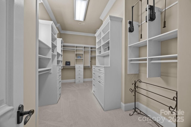 spacious closet featuring visible vents and light colored carpet