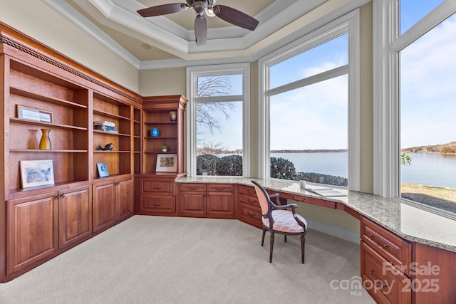 office area featuring a water view, plenty of natural light, and built in desk