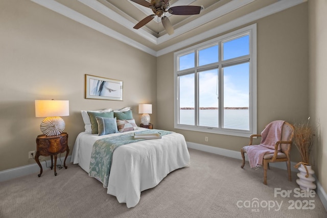 bedroom featuring a water view, light carpet, baseboards, and a raised ceiling