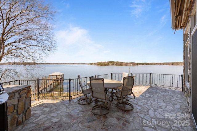 view of patio / terrace featuring outdoor dining area and a water view