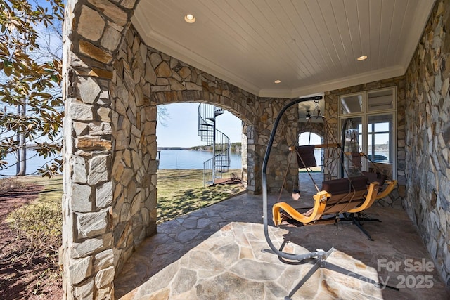 view of patio with a water view