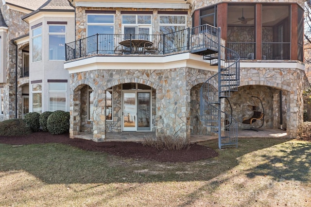 exterior space with a sunroom, a patio area, a balcony, and stairs