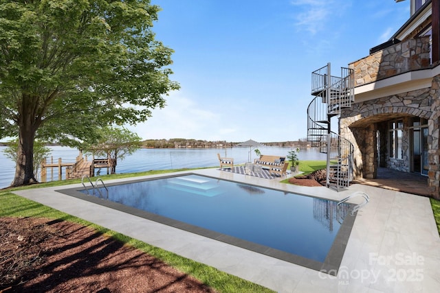 view of swimming pool featuring a water view, a patio area, and stairs