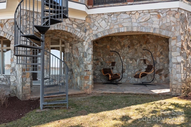 exterior space with a fireplace and stone siding