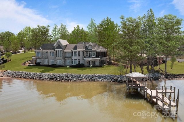 dock area featuring a lawn and a water view