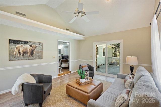 living room featuring baseboards, visible vents, and light wood-style floors