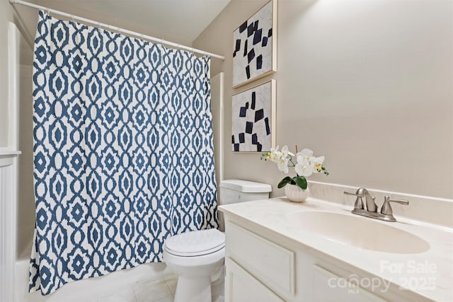 bathroom featuring curtained shower, vanity, toilet, and tile patterned floors