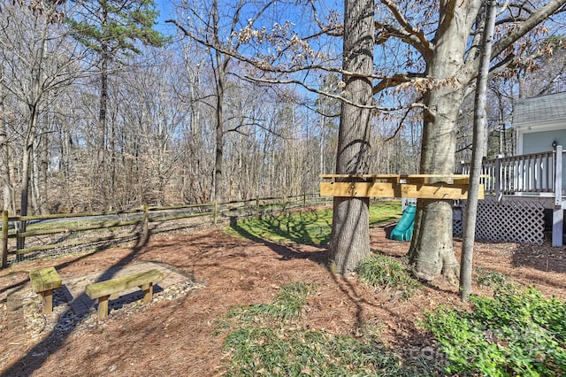 view of yard featuring a deck and fence