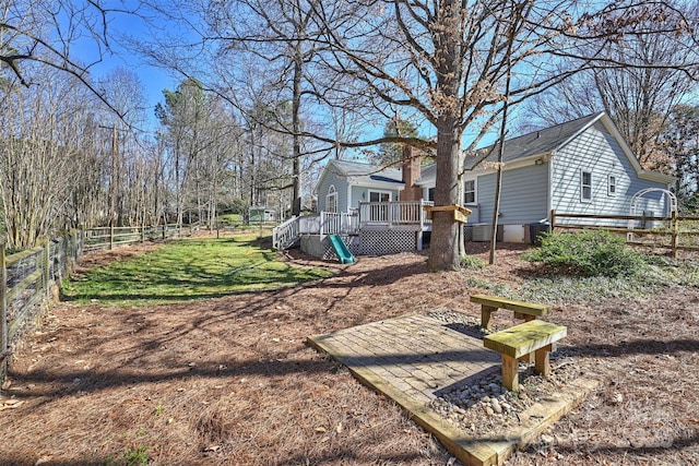 view of yard featuring fence and a wooden deck