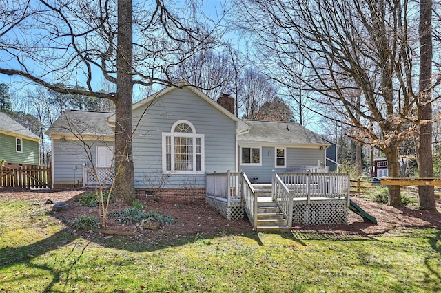 back of property featuring crawl space, fence, a deck, and a lawn