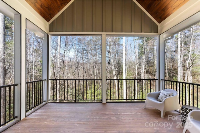 unfurnished sunroom featuring a wealth of natural light, lofted ceiling, and wooden ceiling