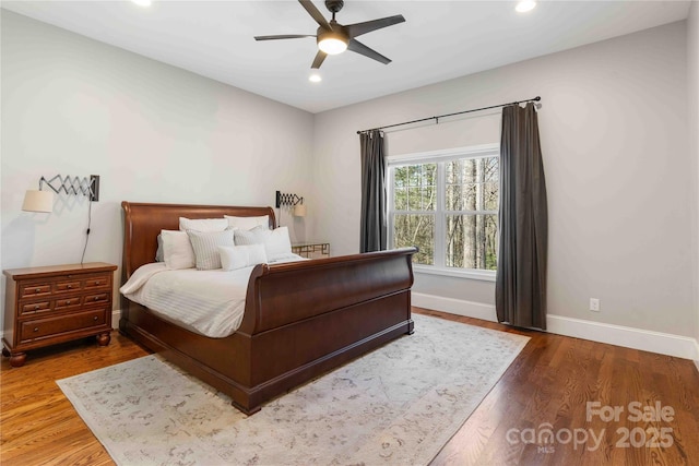 bedroom featuring a ceiling fan, recessed lighting, baseboards, and wood finished floors