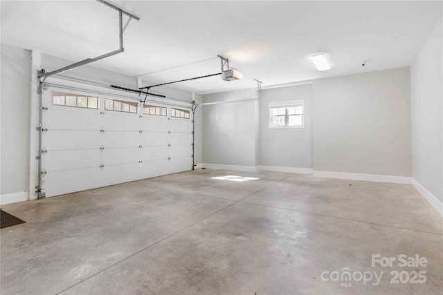 garage with baseboards and a garage door opener