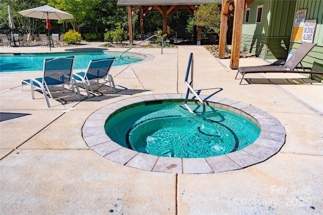 pool featuring a patio and a hot tub