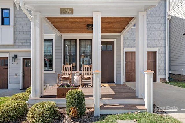 property entrance with a porch and a garage