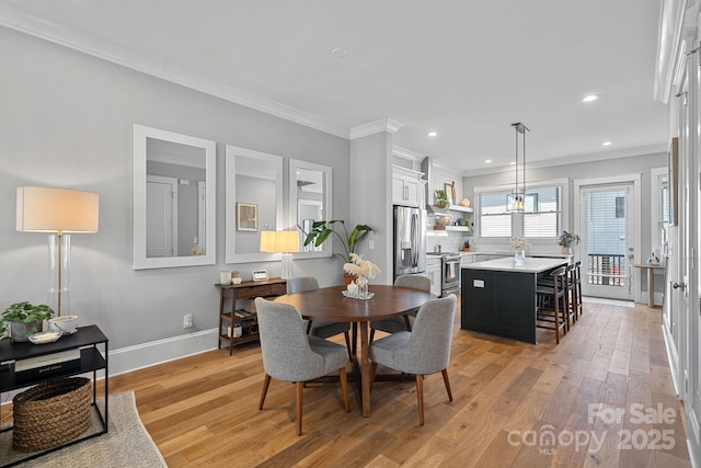 dining room with recessed lighting, light wood-type flooring, baseboards, and crown molding