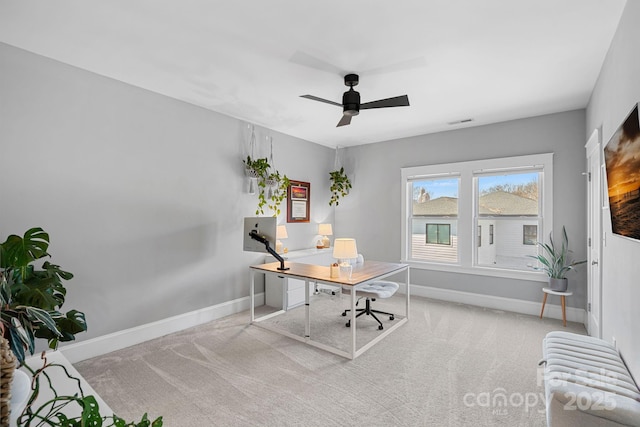 office area featuring visible vents, baseboards, carpet, radiator heating unit, and a ceiling fan