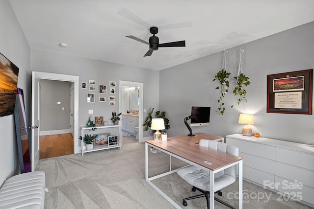 office with light colored carpet and ceiling fan