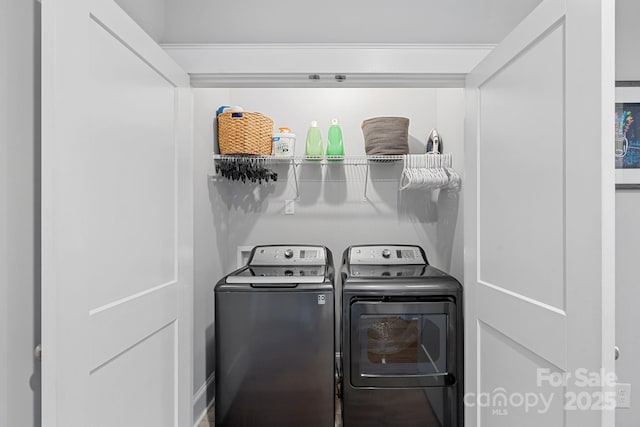 clothes washing area with washing machine and dryer and laundry area