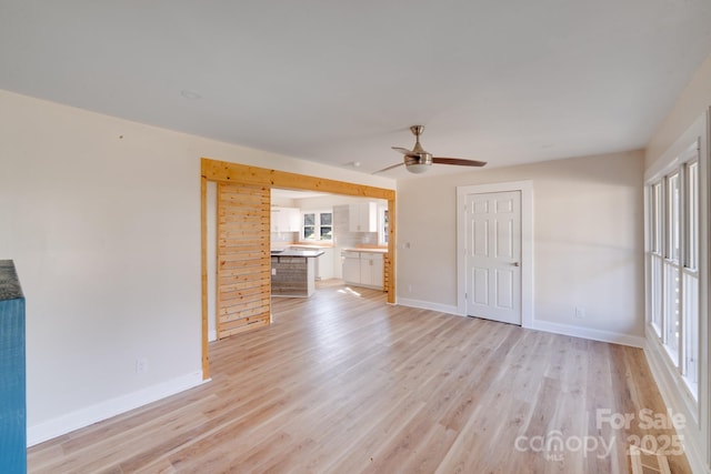 unfurnished living room with light wood-style flooring and plenty of natural light