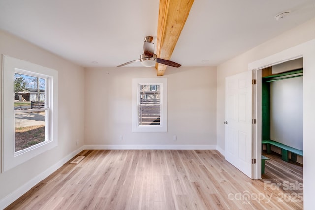 empty room with light wood-style flooring, baseboards, and a ceiling fan