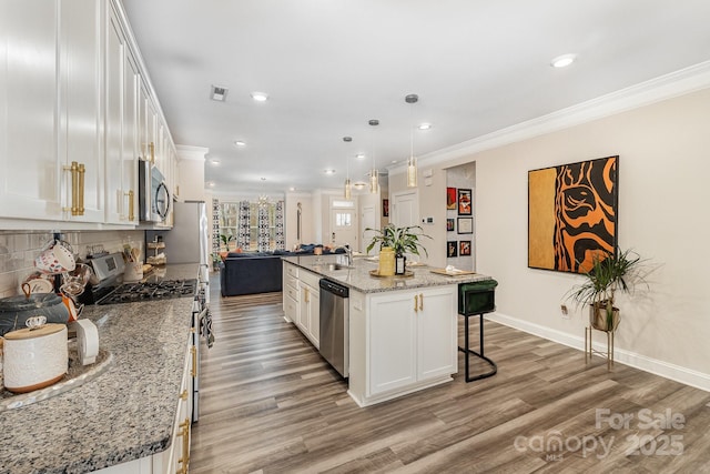kitchen with crown molding, stainless steel appliances, visible vents, white cabinets, and light wood-type flooring