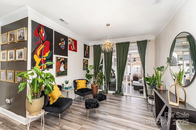 living area with ornamental molding, visible vents, and wood finished floors