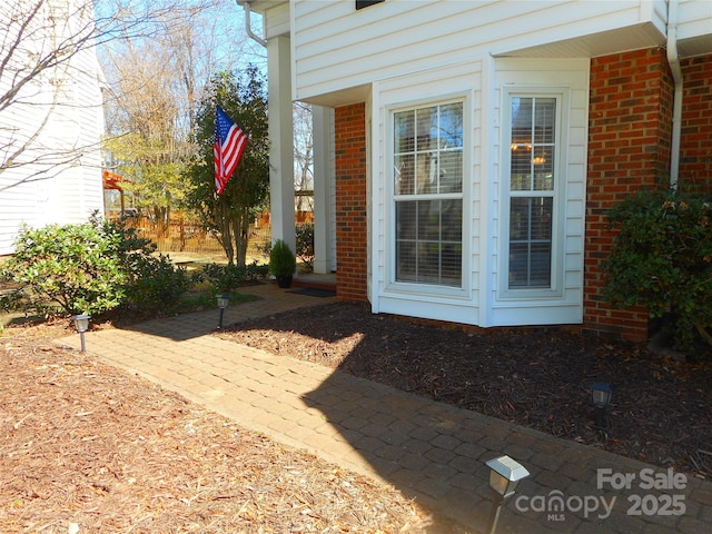 view of exterior entry with brick siding