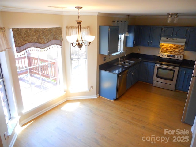 kitchen featuring blue cabinetry, a sink, appliances with stainless steel finishes, dark countertops, and exhaust hood