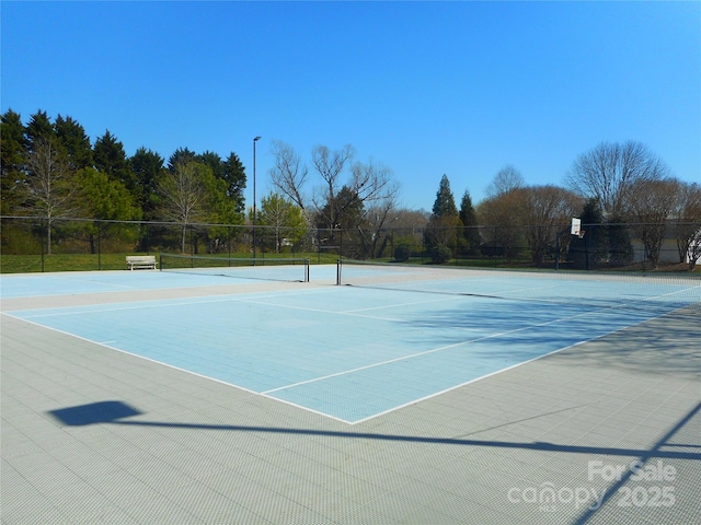 view of tennis court with fence