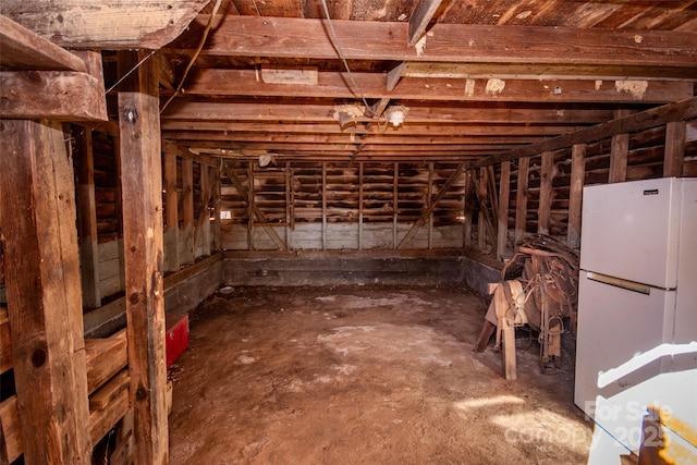 basement featuring freestanding refrigerator