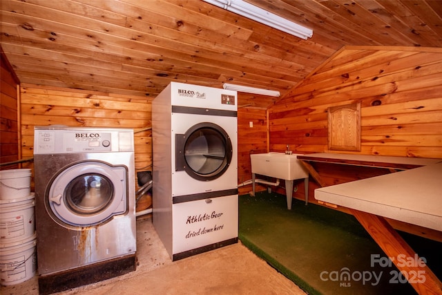 laundry area featuring laundry area, wood ceiling, wooden walls, and washer / clothes dryer