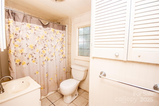 bathroom with toilet, tile patterned flooring, a shower with shower curtain, and vanity