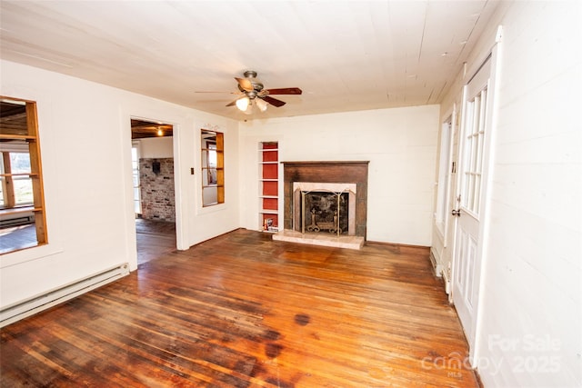 unfurnished living room with a fireplace with raised hearth, ceiling fan, baseboard heating, and wood finished floors