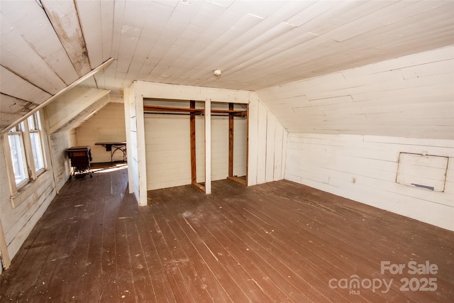 bonus room featuring lofted ceiling, hardwood / wood-style floors, wooden ceiling, and wooden walls