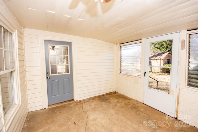 unfurnished sunroom featuring wooden ceiling and vaulted ceiling