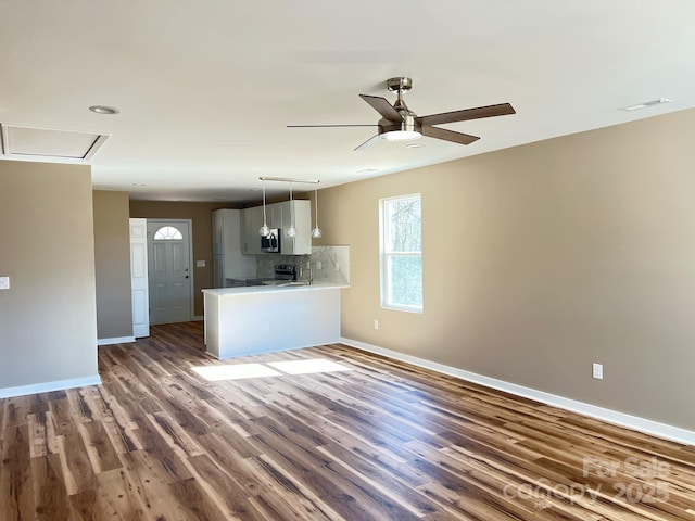 kitchen with visible vents, baseboards, light countertops, decorative backsplash, and dark wood-style flooring